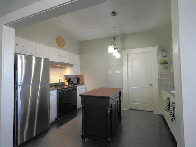 kitchen with hanging light fixtures, a center island, black appliances, backsplash, and white cabinetry