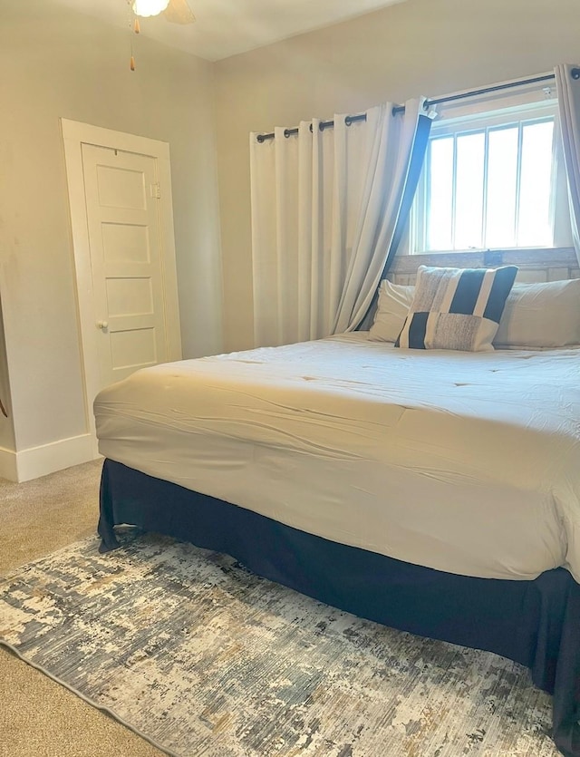 carpeted bedroom with ceiling fan