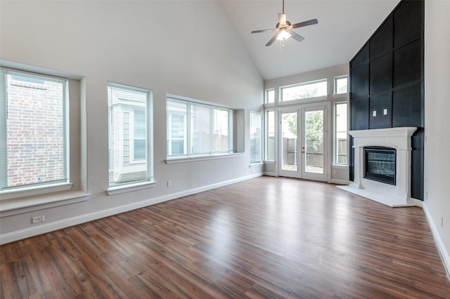 unfurnished living room featuring high vaulted ceiling, ceiling fan, hardwood / wood-style floors, and french doors