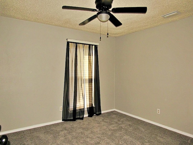 empty room with a textured ceiling, ceiling fan, and carpet