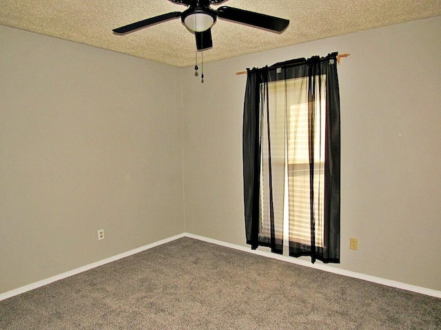 carpeted spare room with a textured ceiling and ceiling fan