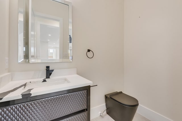 bathroom with toilet and vanity