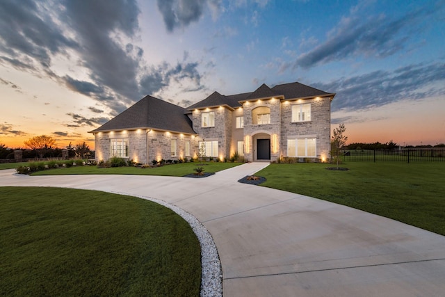 french provincial home featuring a yard