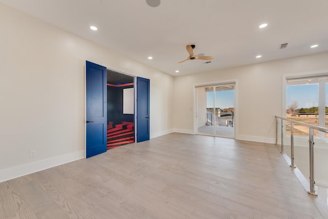 interior space featuring ceiling fan, a wealth of natural light, and light wood-type flooring