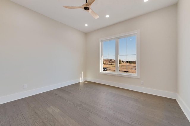 empty room with ceiling fan and hardwood / wood-style floors