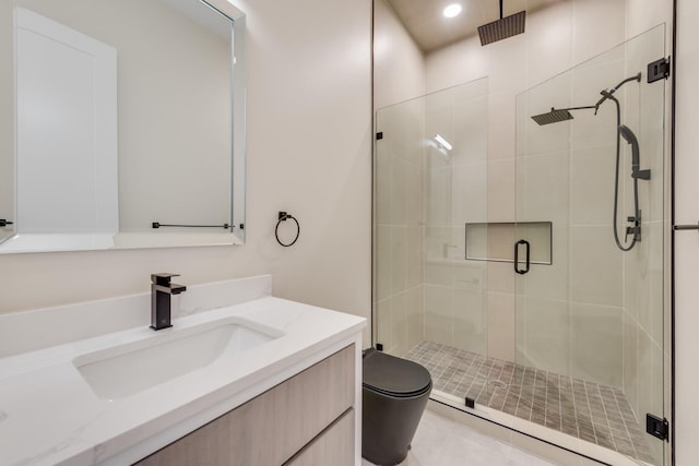 bathroom with vanity, a shower with shower door, and toilet