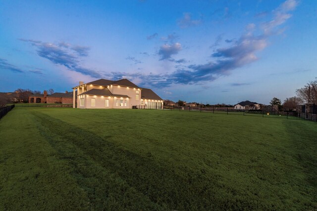 view of yard at dusk