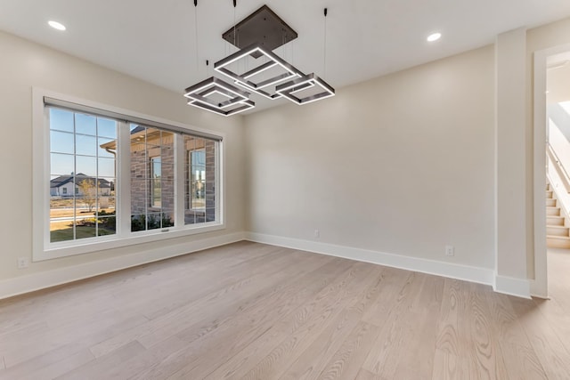 unfurnished dining area featuring light wood-type flooring