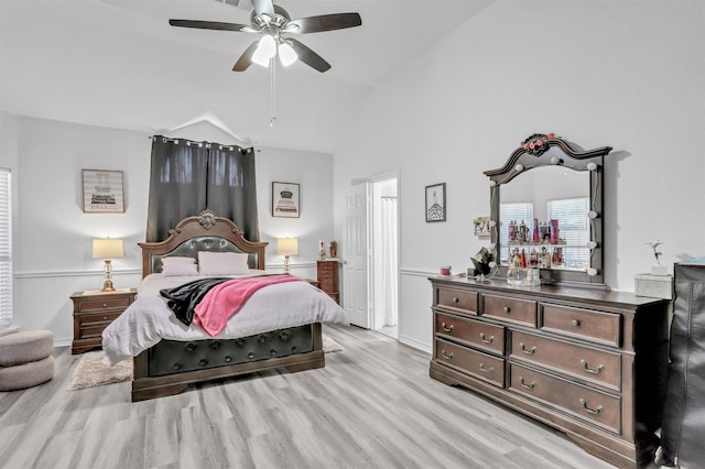 bedroom featuring lofted ceiling, ceiling fan, and light wood-type flooring