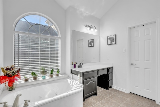 bathroom with lofted ceiling, vanity, and a tub to relax in