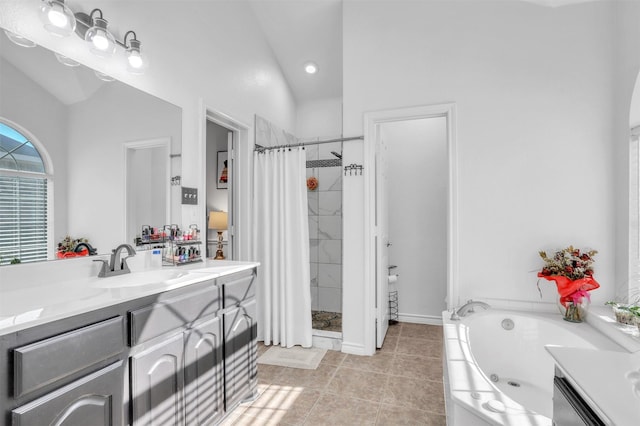 bathroom with lofted ceiling, vanity, tile patterned floors, and independent shower and bath