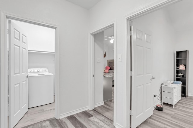 laundry area with ceiling fan, light wood-type flooring, and washer / clothes dryer