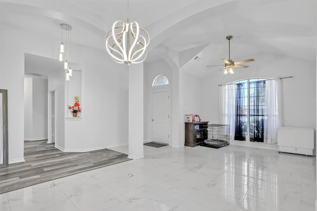 interior space featuring ceiling fan with notable chandelier and lofted ceiling