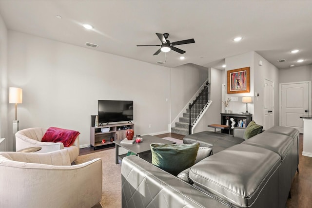 living room featuring dark wood-type flooring and ceiling fan