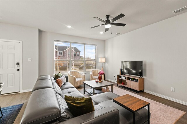 living room with ceiling fan and hardwood / wood-style flooring