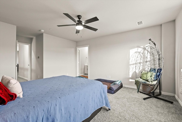 carpeted bedroom with ceiling fan and ensuite bath