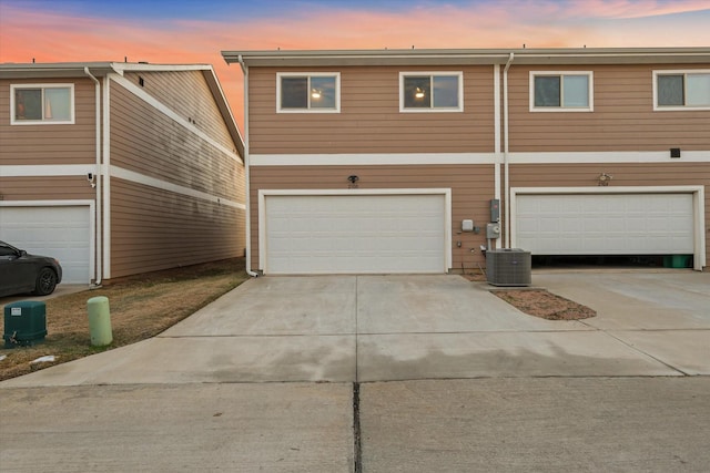 view of front property with a garage and central air condition unit