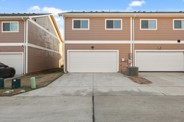 view of front property featuring cooling unit and a garage