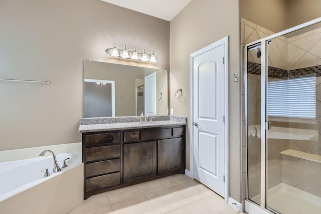 bathroom with vanity, tile patterned flooring, and plus walk in shower