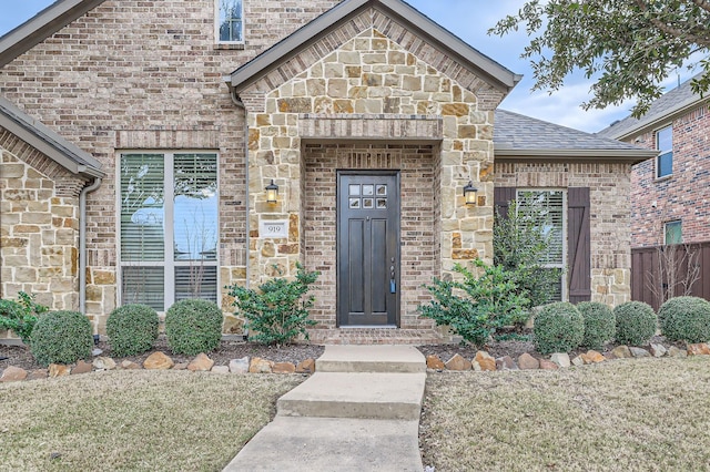 property entrance with a lawn