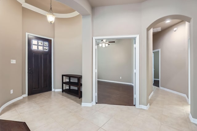 tiled entryway featuring ceiling fan