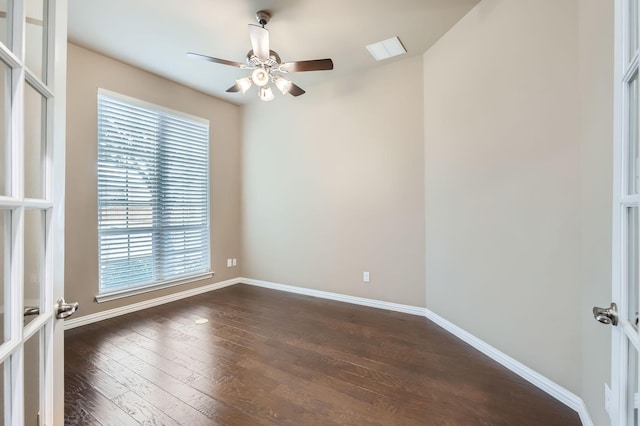 empty room with ceiling fan, french doors, and dark hardwood / wood-style floors