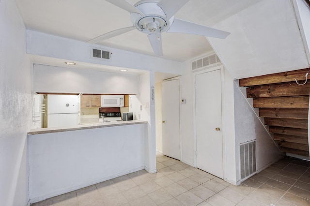 kitchen featuring white appliances, white cabinets, and ceiling fan