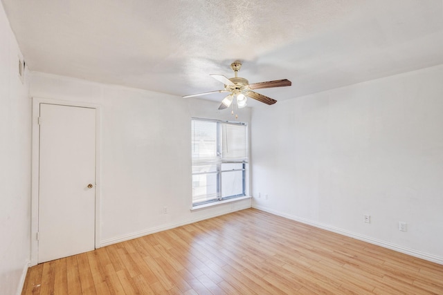 unfurnished room with a textured ceiling, ceiling fan, and light hardwood / wood-style flooring