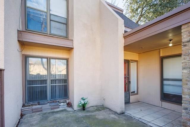 view of exterior entry featuring a patio