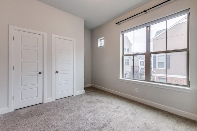 unfurnished bedroom featuring light colored carpet