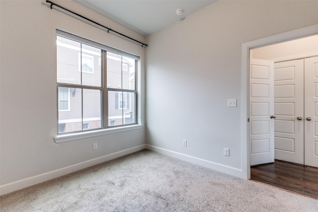 carpeted spare room featuring plenty of natural light