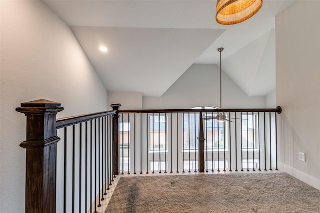 stairway featuring carpet flooring and vaulted ceiling