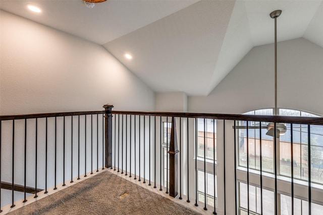 corridor with carpet, a wealth of natural light, and vaulted ceiling