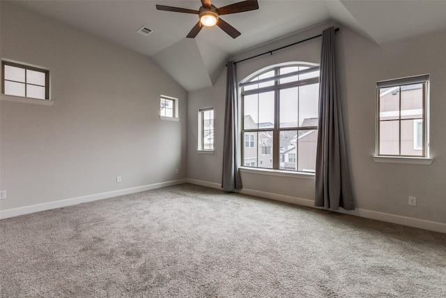 spare room with vaulted ceiling, light colored carpet, and ceiling fan