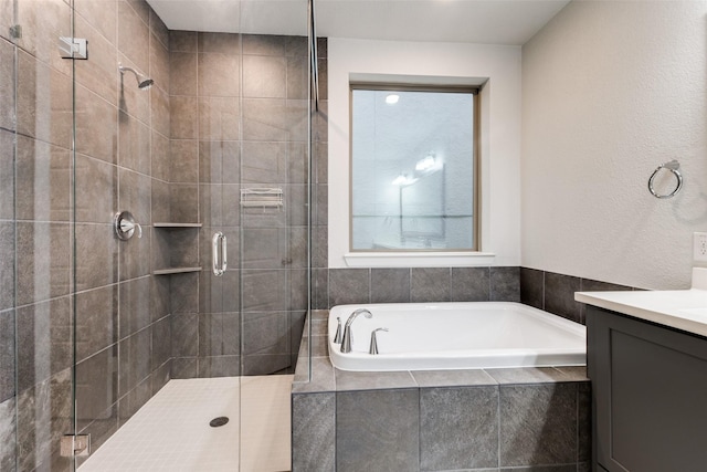 bathroom with vanity and independent shower and bath