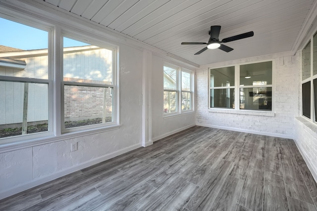 unfurnished sunroom featuring wood ceiling and ceiling fan