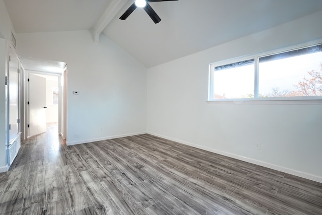 spare room with vaulted ceiling with beams, a ceiling fan, baseboards, and wood finished floors