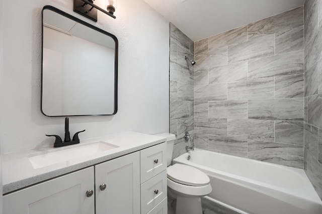 bathroom with toilet, shower / bathing tub combination, and vanity