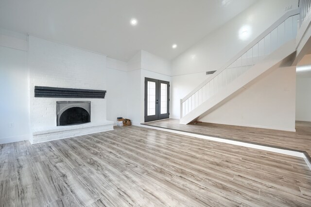 stairs with a high ceiling, hardwood / wood-style floors, and ceiling fan