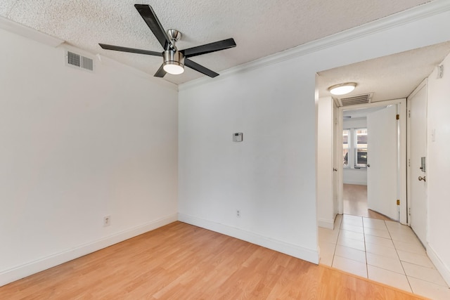 unfurnished room featuring ceiling fan, crown molding, light hardwood / wood-style floors, and a textured ceiling