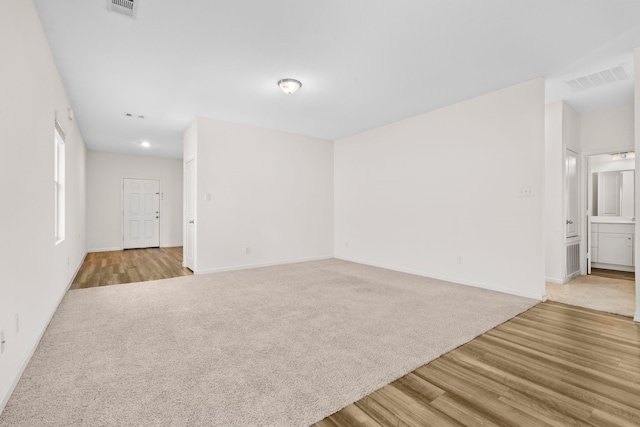 empty room with light hardwood / wood-style floors