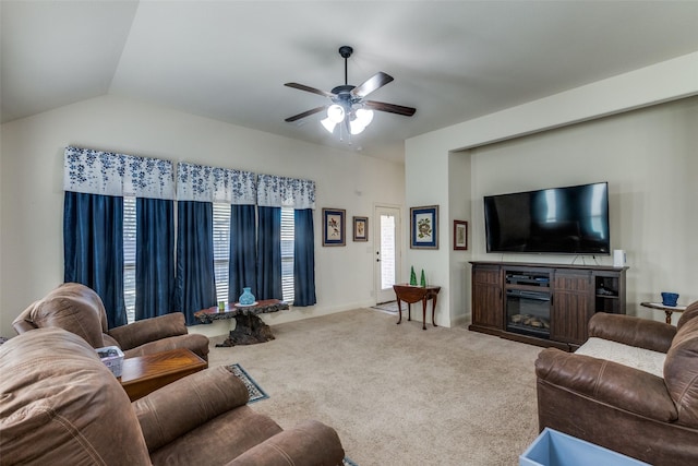 carpeted living room with ceiling fan and lofted ceiling