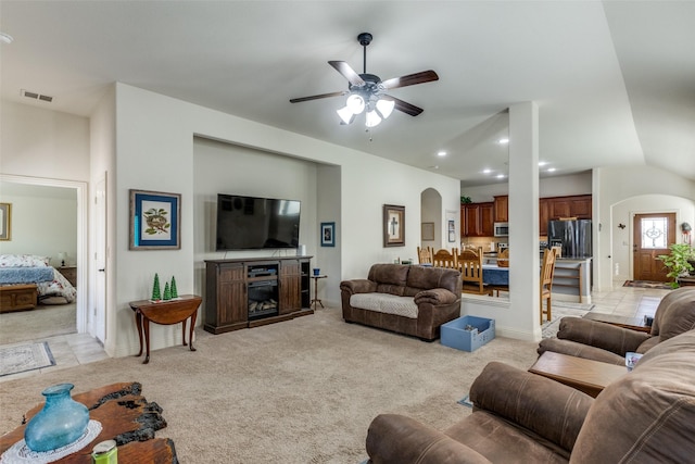 living room with ceiling fan, light carpet, and lofted ceiling