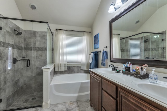 bathroom with plus walk in shower, lofted ceiling, and vanity