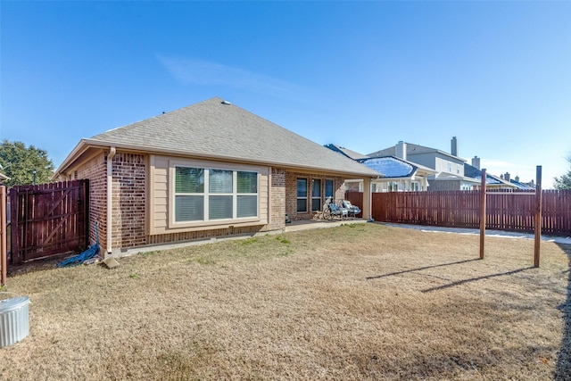 rear view of house featuring a lawn