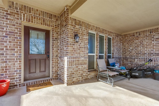 view of exterior entry with covered porch