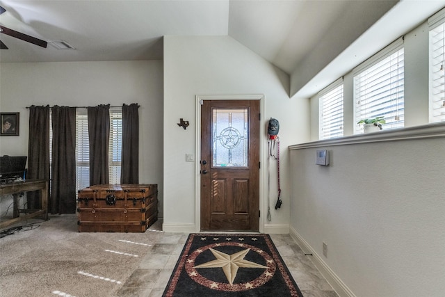 carpeted foyer entrance with ceiling fan and lofted ceiling