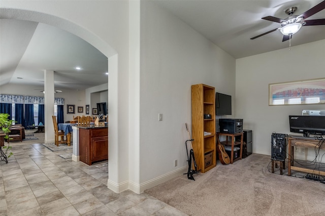 carpeted living room with ceiling fan and lofted ceiling