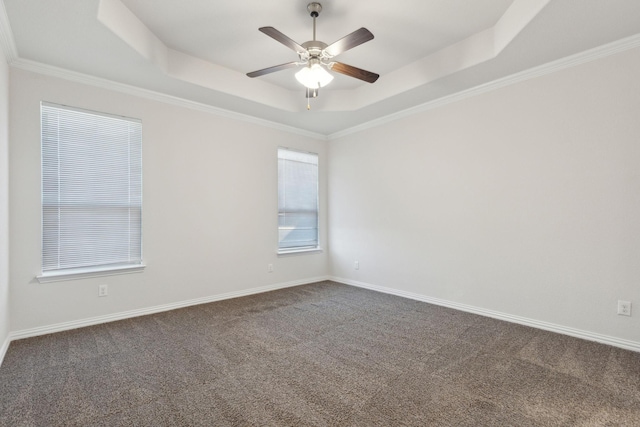 unfurnished room featuring ceiling fan, crown molding, carpet, and a raised ceiling