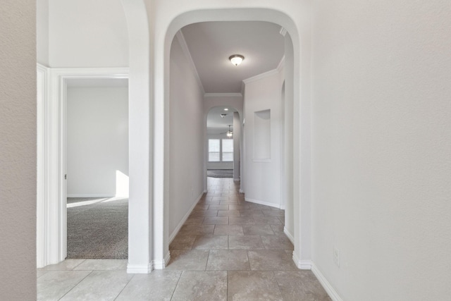 corridor featuring light carpet and crown molding